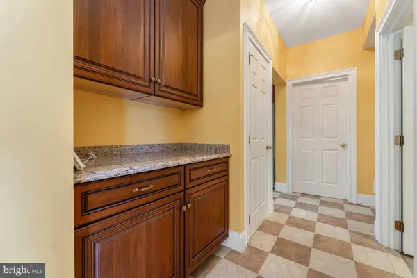 a view of a kitchen with wooden floor and cabinets