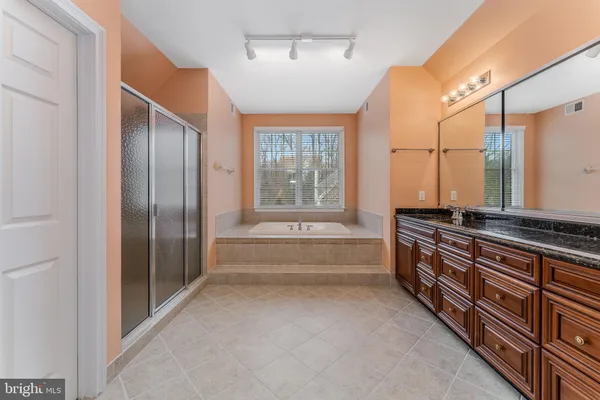 a large spacious bathroom with a large tub and shower
