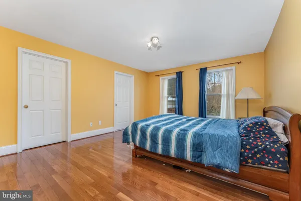 a bedroom with a large bed and a chandelier