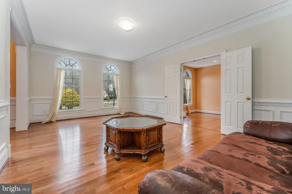 a bedroom with furniture and a wooden floor