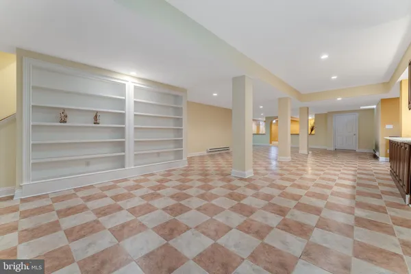 a room with a checkered floor and view of a bathroom