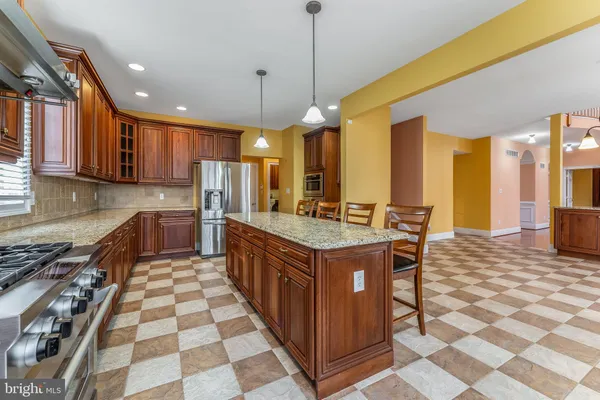 a kitchen with stainless steel appliances granite countertop a sink and a cabinets