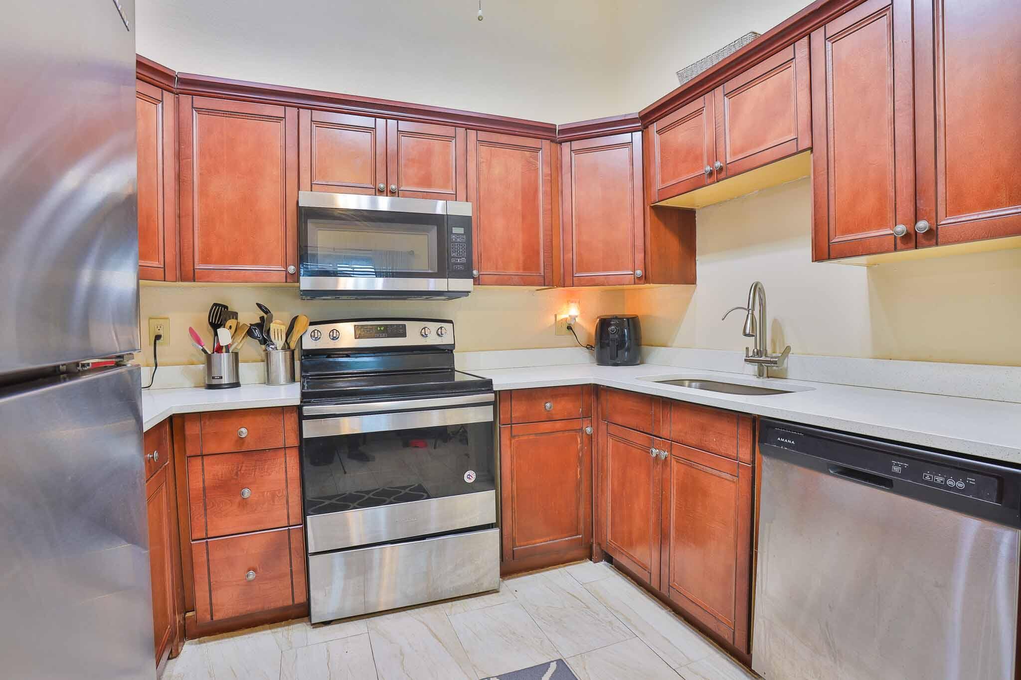 11223 Model Circle West Boca Raton, FL 33428 - Photo 8 of 35 a kitchen with granite countertop a stove top oven sink and cabinets