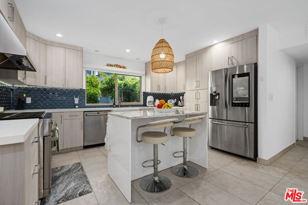 13231 Fiji Way, Unit F Marina del Rey, CA 90292 - Photo 17 of 40 a kitchen with a sink cabinets and stainless steel appliances