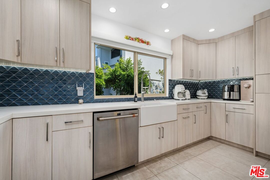 13231 Fiji Way, Unit F Marina del Rey, CA 90292 - Photo 18 of 40 a kitchen with white cabinets and window