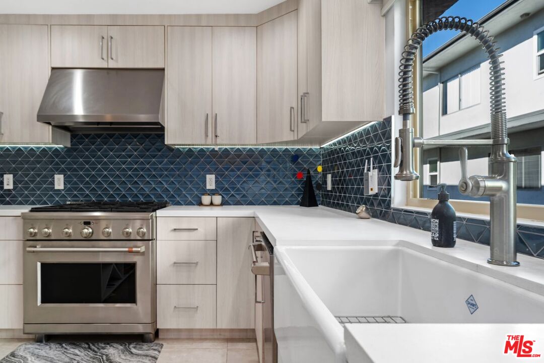 13231 Fiji Way, Unit F Marina del Rey, CA 90292 - Photo 19 of 40 a kitchen with granite countertop a sink and a stove