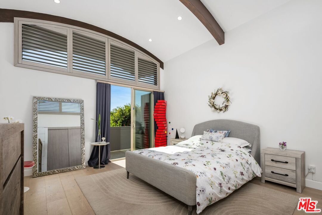 13231 Fiji Way, Unit F Marina del Rey, CA 90292 - Photo 21 of 40 a bedroom with a large bed and a chandelier