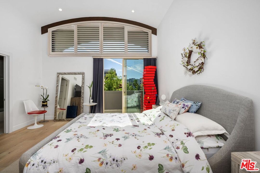 13231 Fiji Way, Unit F Marina del Rey, CA 90292 - Photo 24 of 40 a bedroom with a bed and dresser with mirror