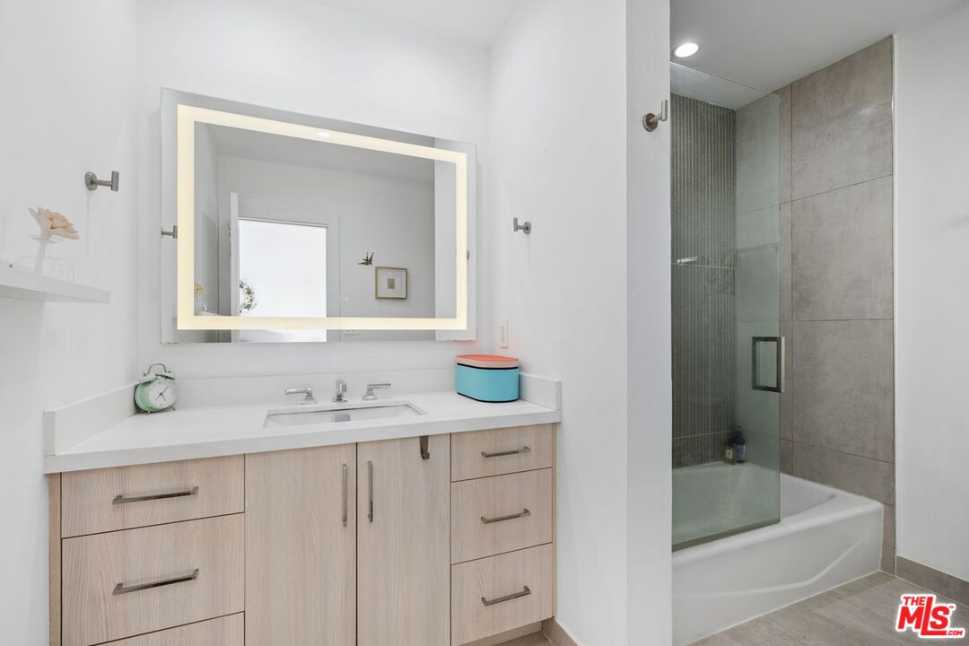 13231 Fiji Way, Unit F Marina del Rey, CA 90292 - Photo 25 of 40 a bathroom with a sink and a mirror