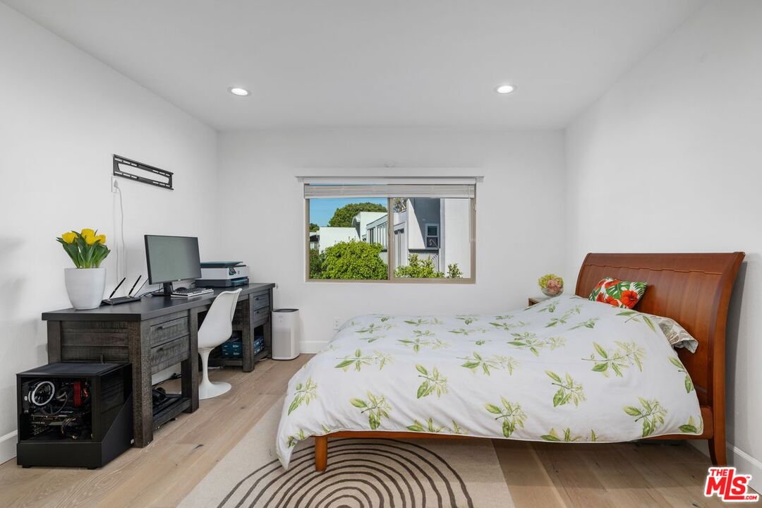 13231 Fiji Way, Unit F Marina del Rey, CA 90292 - Photo 27 of 40 a bedroom with a bed table and a window