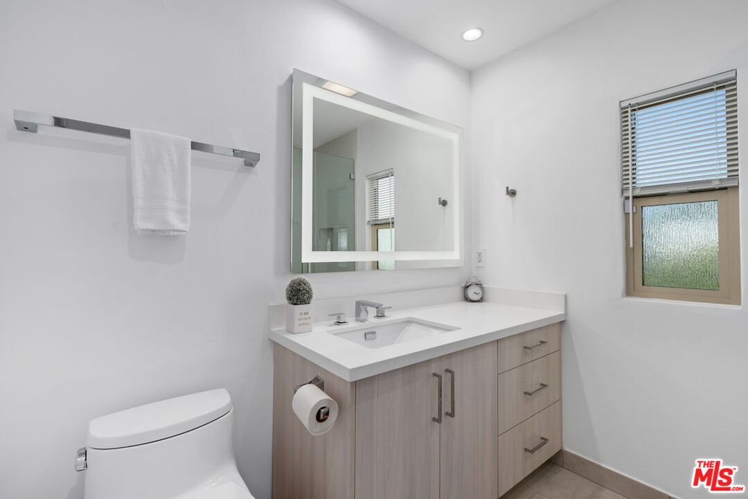 13231 Fiji Way, Unit F Marina del Rey, CA 90292 - Photo 31 of 40 a bathroom with a sink toilet and mirror