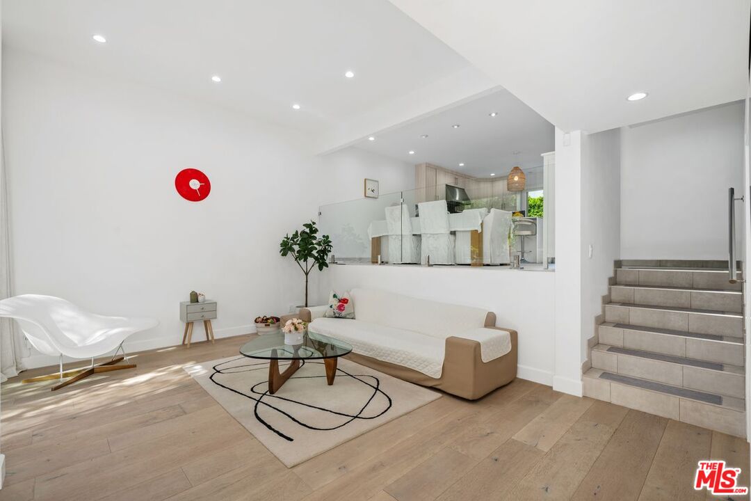 13231 Fiji Way, Unit F Marina del Rey, CA 90292 - Photo 5 of 40 a living room with kitchen island furniture and a chandelier