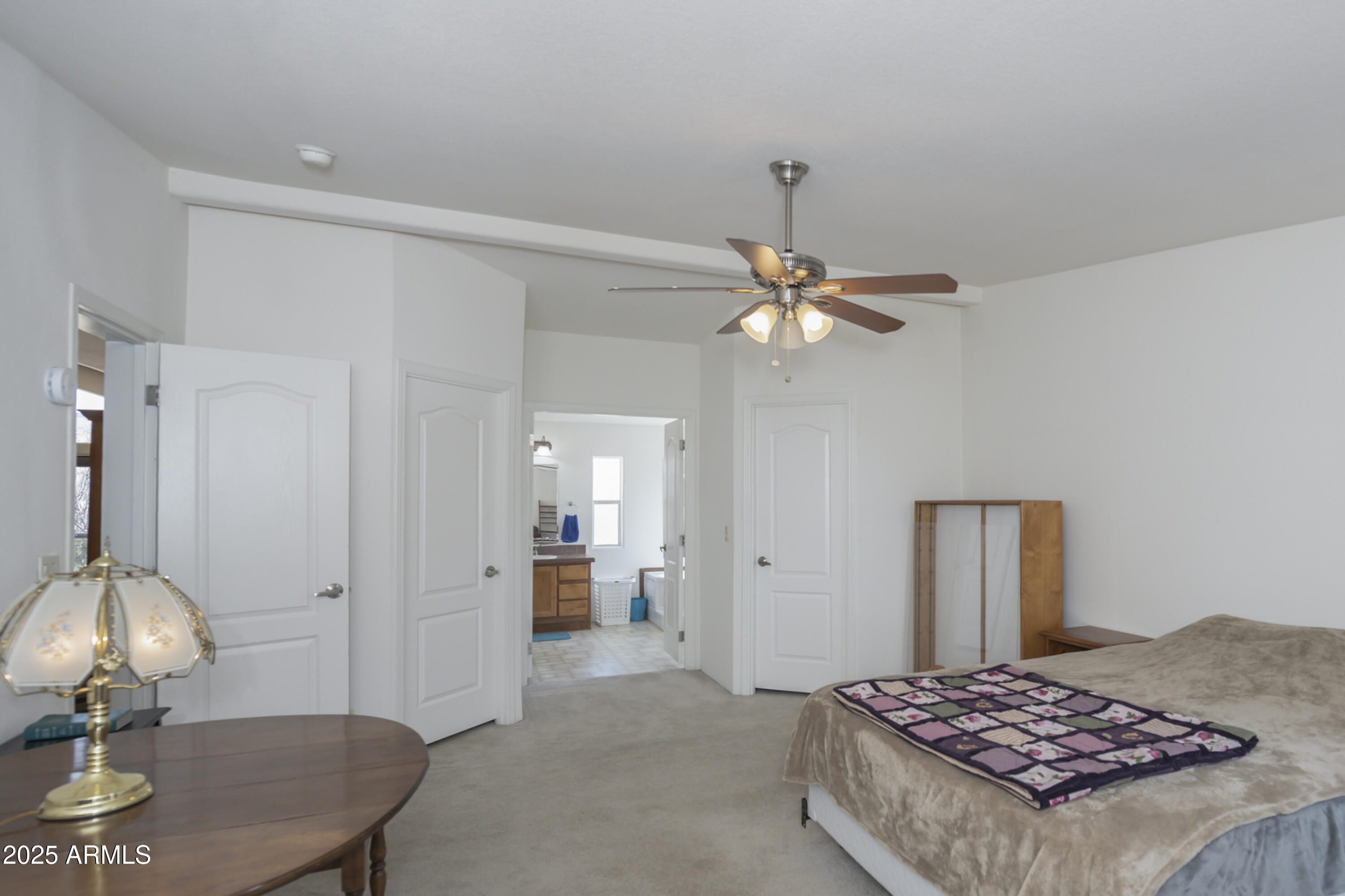 17985 Hunters Lane Dewey, AZ 86327 - Photo 24 of 45 a bedroom with a bed and a chandelier