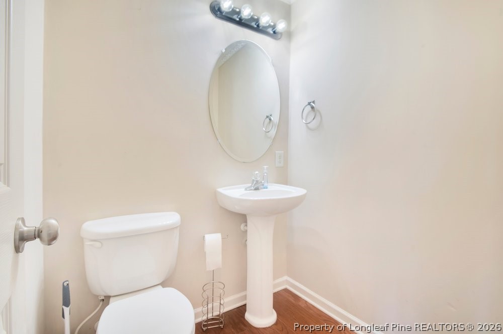10 Pender Road Spring Lake, NC 28390 - Photo 8 of 35 a bathroom with a toilet a sink and mirror