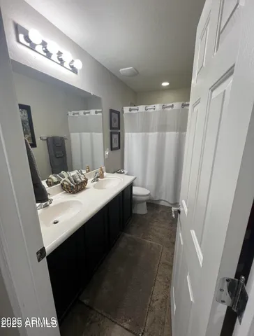 a bathroom with a double vanity sink and a mirror