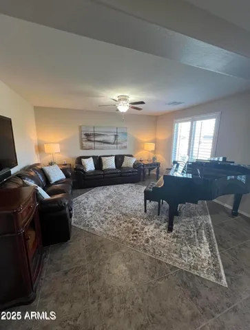 a living room with furniture a rug and kitchen view