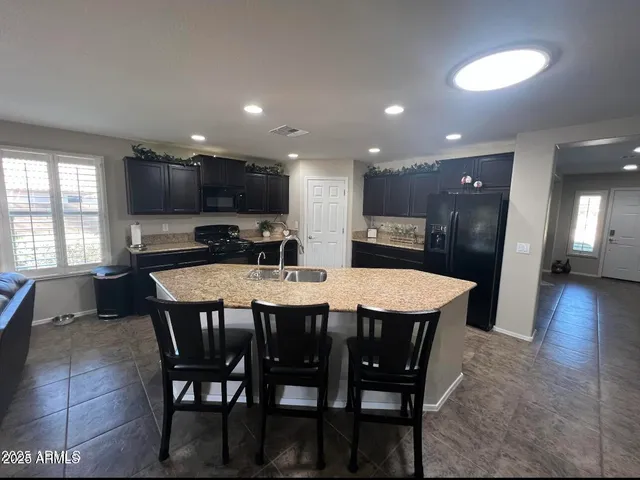 a large kitchen with a table and chairs