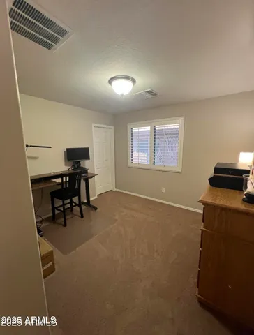 a view of workspace with furniture and a window