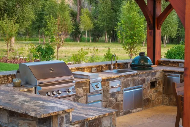 a backyard of a house with yard table and chairs