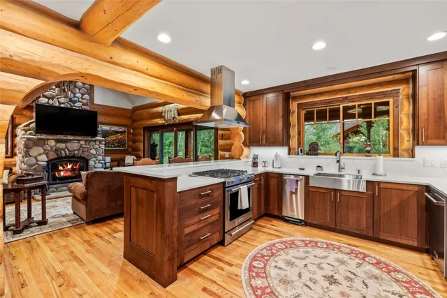 a kitchen with stainless steel appliances granite countertop a stove and large cabinets