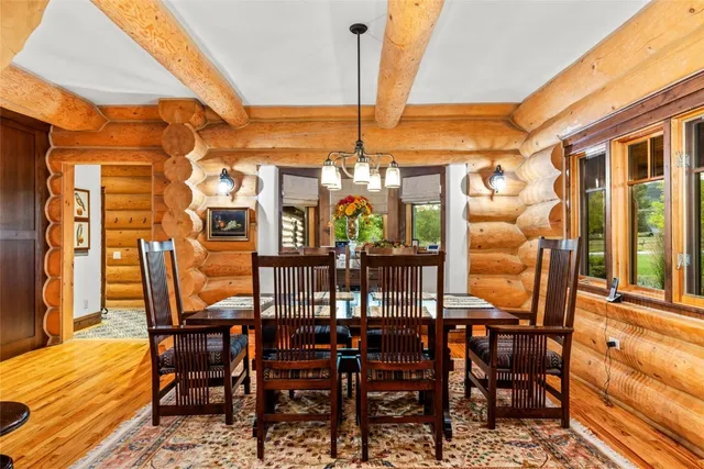 a view of a dining room with furniture and chandelier