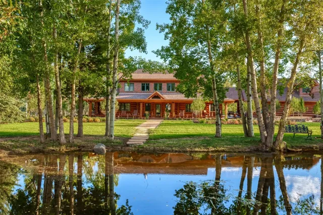 a front view of a house with a yard table and chairs