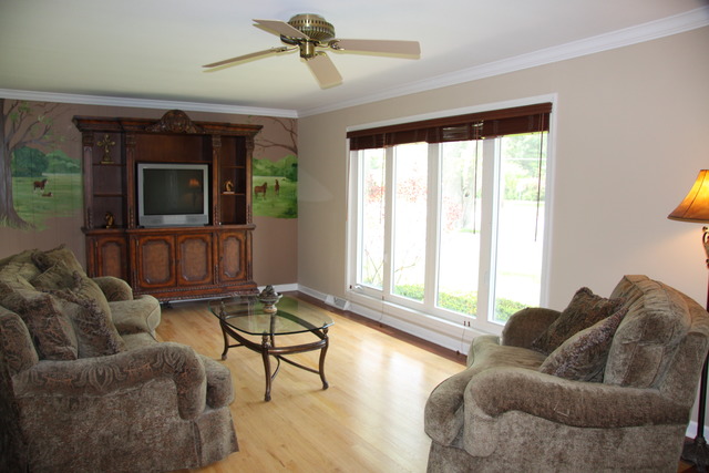 605 East Baldwin Road Palatine, IL 60074 - Photo 2 of 18 a living room with furniture and a flat screen tv