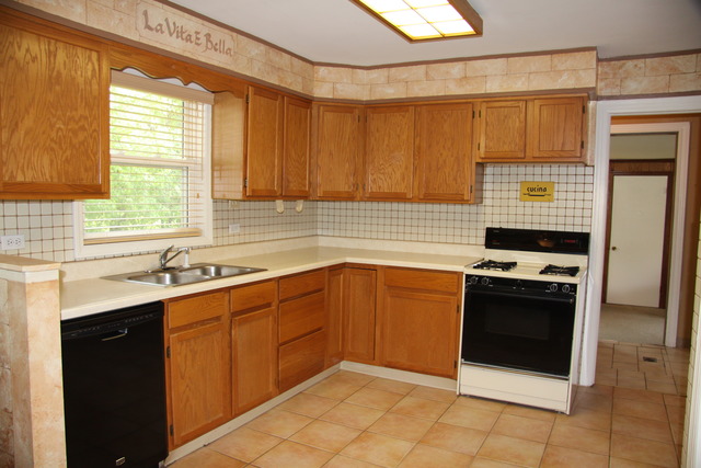 605 East Baldwin Road Palatine, IL 60074 - Photo 5 of 18 a kitchen with a sink stove and cabinets