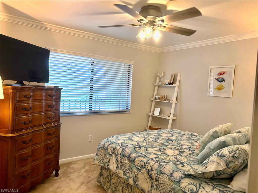 5841 Rattlesnake Hammock Road, Unit I203 Naples, FL 34113 - Photo 17 of 24 a bedroom with a bed and a flat screen tv