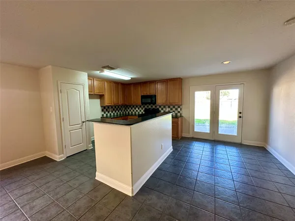 a large white kitchen with a sink and refrigerator