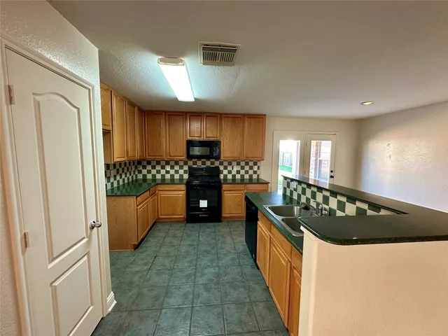 a kitchen with stainless steel appliances a refrigerator and a stove
