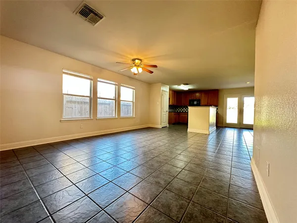 a bathroom with a shower and a wooden floor