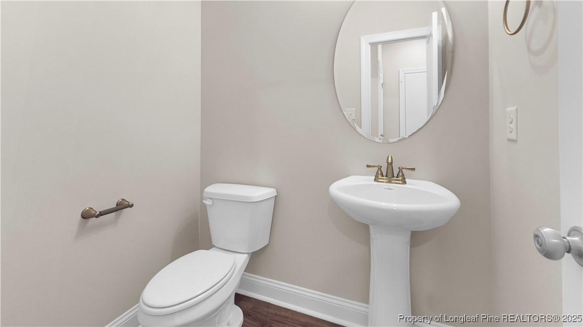 162 Surles Landing Way Benson, NC 27504 - Photo 14 of 28 a bathroom with a toilet sink and mirror