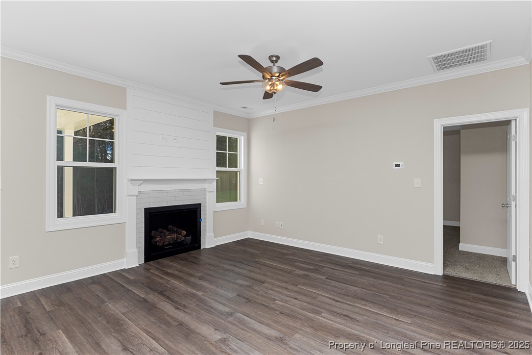 162 Surles Landing Way Benson, NC 27504 - Photo 6 of 28 an empty room with windows and fireplace