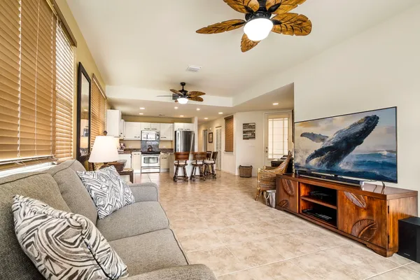 a living room with furniture and a chandelier