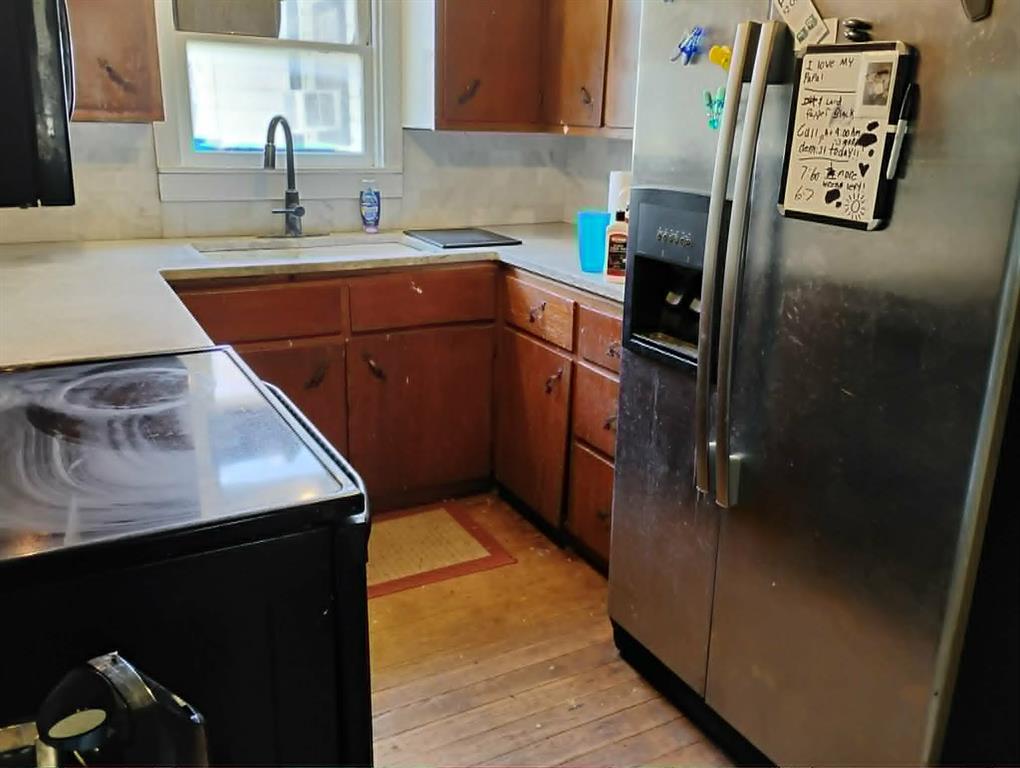 763 Frontier Street Bowie, TX 76230 - Photo 20 of 28 a kitchen with stainless steel appliances a refrigerator sink and cabinets