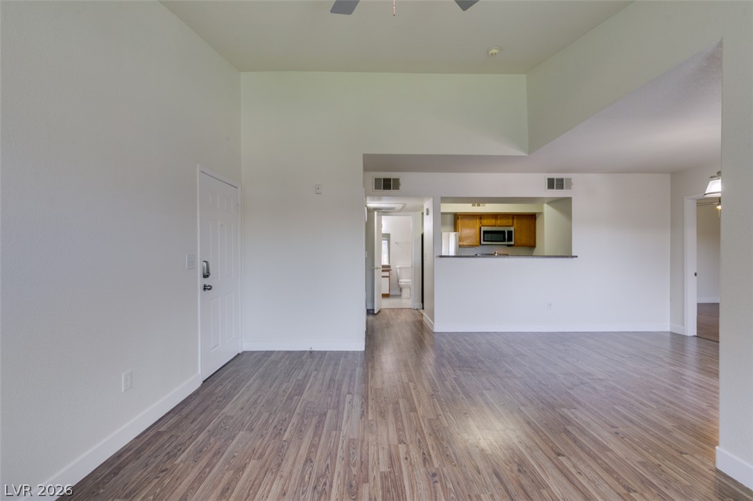 6650 West Warm Springs Road, Unit 2118 Las Vegas, NV 89118 - Photo 29 of 41 An open concept living area features resilient wood-look flooring and a functional pass-through to the kitchen.