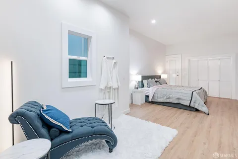a bedroom with a bed and a couch