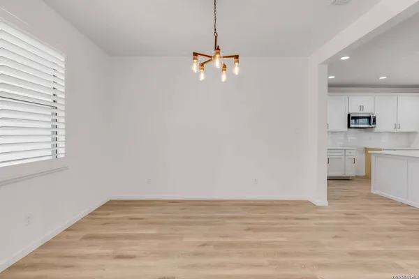 a view of a kitchen and an empty room