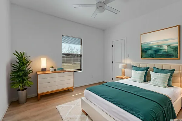 a bedroom with bed and a large window