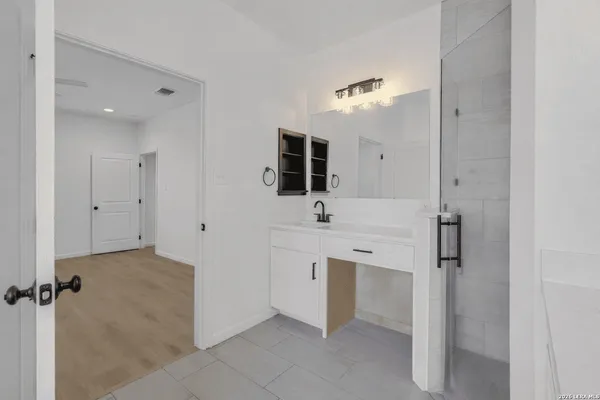 a bathroom with a double vanity sink mirror and