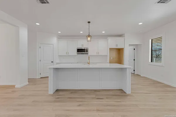 a view of kitchen with wooden floor and window