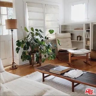 a living room with furniture and a lamp