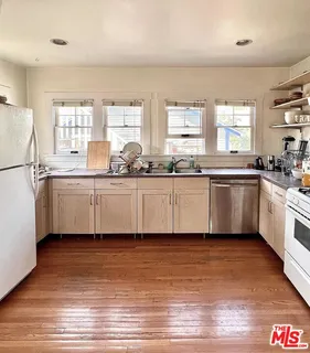a kitchen with stainless steel appliances granite countertop a sink and cabinets