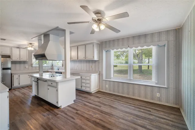 a kitchen with stainless steel appliances a lot of counter space and a window