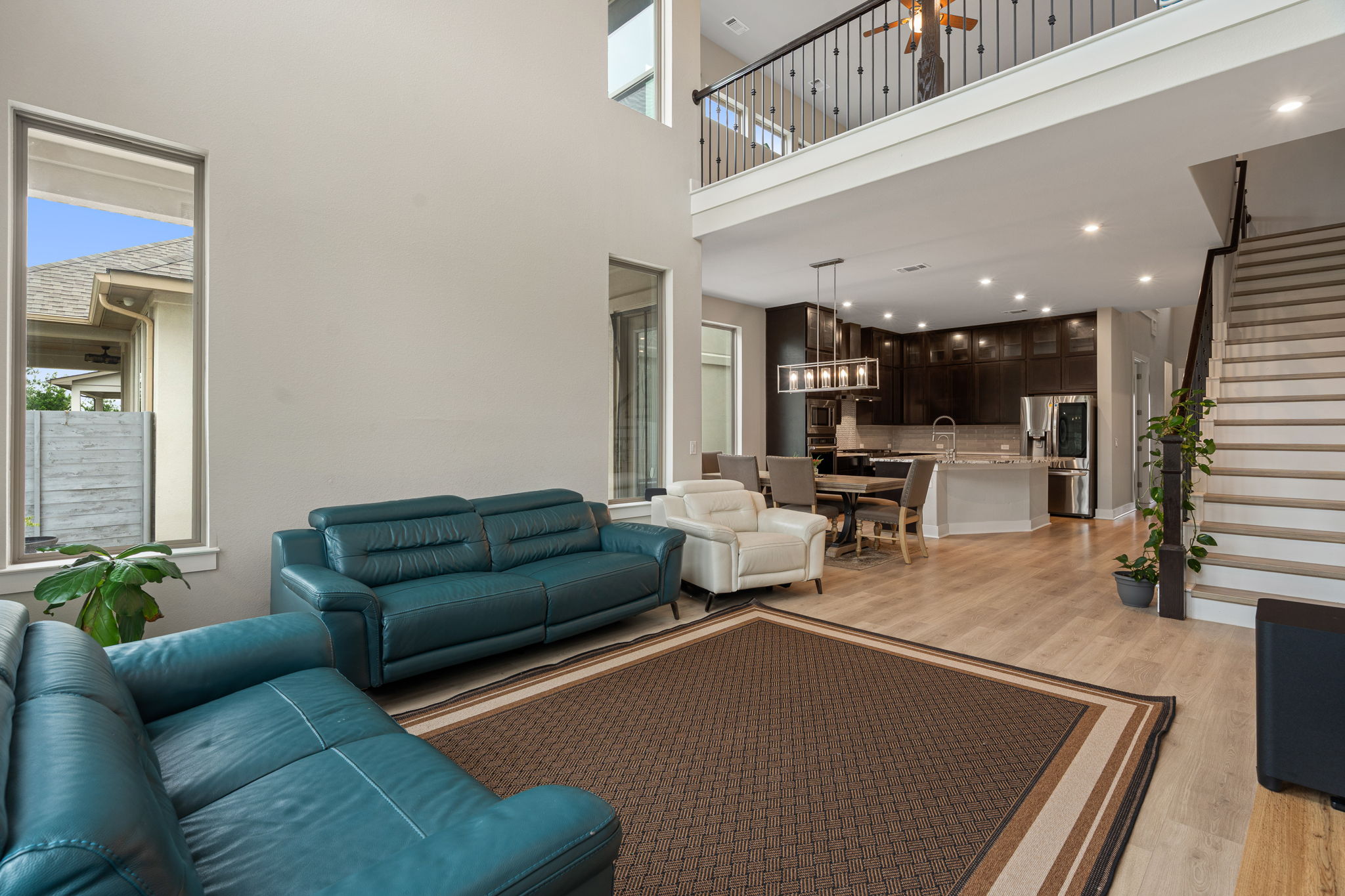 244 Diamondback Drive Georgetown, TX 78628 - Photo 16 of 37 Spacious living area featuring double-height ceilings, and ample natural light from tall windows.