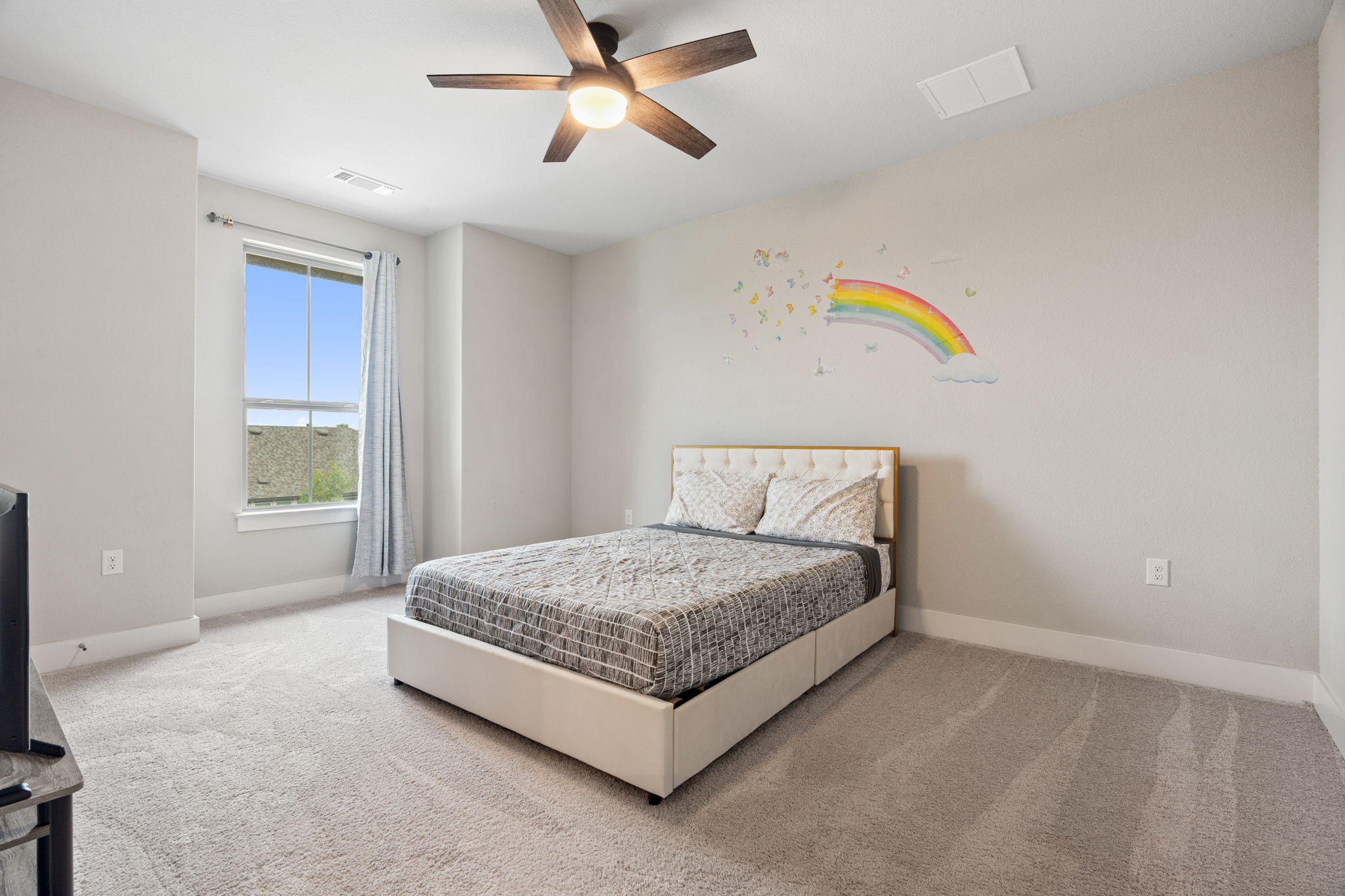 244 Diamondback Drive Georgetown, TX 78628 - Photo 28 of 37 Carpeted room featuring a ceiling fan with integrated lighting, a single window with curtain rod, and light-toned walls.