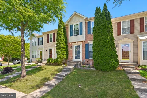 a front view of a house with a yard and porch