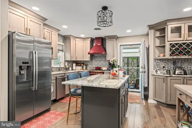 a kitchen with stainless steel appliances granite countertop a refrigerator and a sink