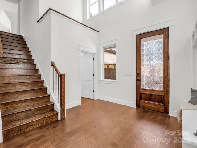 a view of an entryway with wooden floor and door